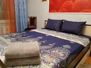 スタールイ・オスコルにあるКвартира на Королеваのベッド(青と白の掛け布団付)