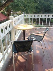 a table and two chairs sitting on a patio at The Old Palace Resort Klong Sa Bua in Phra Nakhon Si Ayutthaya