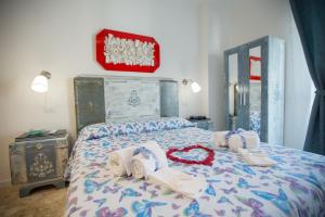 a bedroom with a bed with towels on it at Versomare in Polignano a Mare