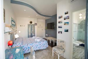 a bedroom with a bed and a bathroom at Versomare in Polignano a Mare