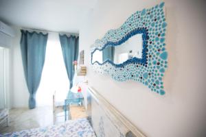 a bedroom with a mirror on the wall at Versomare in Polignano a Mare