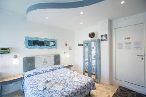 a bedroom with a bed with stuffed animals on it at Versomare in Polignano a Mare