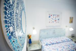 a bedroom with a bed and a table and a mirror at Versomare in Polignano a Mare