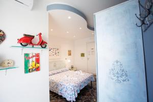 a bedroom with a bed and a scooter on the wall at Versomare in Polignano a Mare