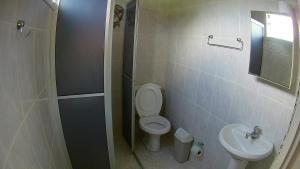 a bathroom with a toilet and a sink at Pousada Águas Formosas in Ubatuba