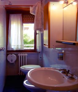 a bathroom with a sink and a toilet and a window at Hotel Blu in Rieti