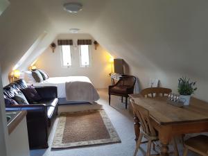 a living room with a bed and a table at The Barn Tarporley in Tarporley