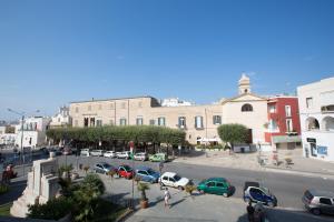 a city with cars parked in a parking lot at Versomare in Polignano a Mare