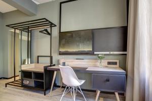 a kitchen with a desk and a table with a chair at Central Hotel am Dom - Köln City in Cologne