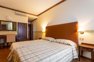 Letto o letti in una camera di Albergo Il Cacciatore