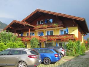 three cars parked in front of a building at Hotel Alp Inn in Ruhpolding