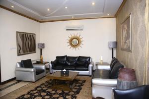 a living room with couches and a coffee table at Safari Club 2 Bahria Town in Rawalpindi