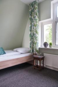 מיטה או מיטות בחדר ב-Heerlijk Huis aan het IJsselmeer