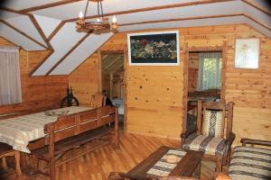 a room with a bed in a log cabin at Guest House Veronika in Dilijan