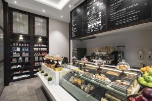a bakery with a display case in a store at Centro Salama Jeddah by Rotana in Jeddah