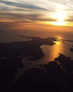 an aerial view of the ocean at sunset at L améthystes in Crozon