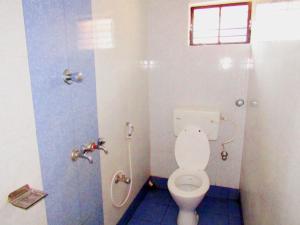 a bathroom with a toilet and a shower at Lodge Lipika in Bolpur