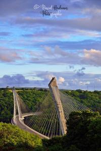 a suspension bridge in the middle of a field at L améthystes in Crozon