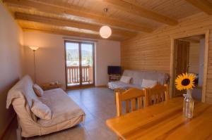 a living room with a couch and a table at Sno Apartments in Szczyrk