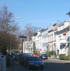a street with cars parked on the side of the road at Ferienwohnung am Schloss in Karlsruhe