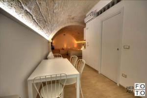 a dining room with a white table and chairs at Suite Stone Luxury in Monopoli