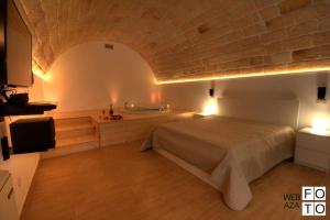 a bedroom with a bed and a tv in a room at Suite Stone Luxury in Monopoli