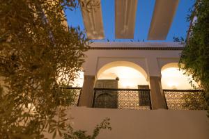 a house with arches and a fence at Riad Magellan in Marrakesh