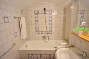 a bathroom with a tub and a sink at Le Tartarughe Boutique Apartment in Rome