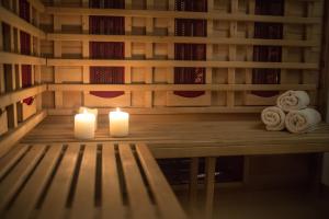 two candles sitting on a bench in a library at Skopelos Holidays Hotel & Spa in Skopelos Town