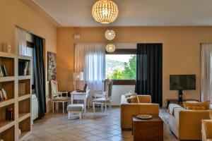 a living room with a couch and a table at Skopelos Holidays Hotel & Spa in Skopelos Town