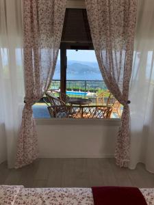 a bedroom with a window with a view of a pool at Villa Marisa in Nebbiuno