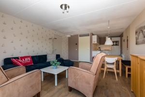 a living room with a couch and chairs and a table at Nautic Rentals - Marinapark Oude-Tonge in Oude-Tonge +100 photos