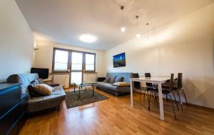 a living room with a couch and a table at Wyspa Uznam - Wyspa Uznam in Świnoujście