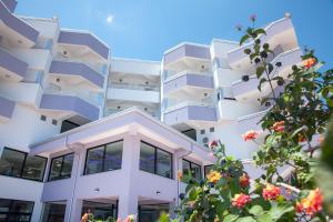 an apartment building with balconies and flowers at Hotel Melissa in Torre Melissa