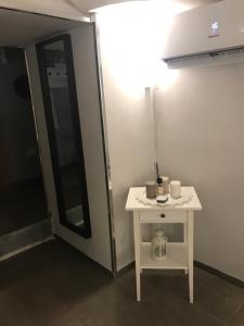 a small white table in a room with a mirror at Casa Azzurra in Naples