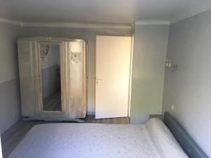 an empty bedroom with a bed and a mirror at Gite à Sarlat avec piscine in Sarlat-la-Canéda +10 photos