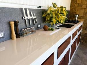 a kitchen with a white counter top and a sink at Romantic Beachfront Retreat in San Juan del Sur