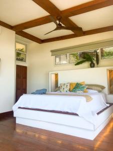 a bedroom with a large white bed in a room at Romantic Beachfront Retreat in San Juan del Sur