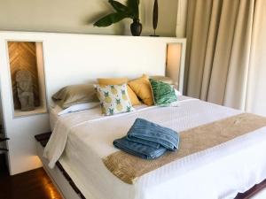 a bedroom with a white bed with pillows at Romantic Beachfront Retreat in San Juan del Sur