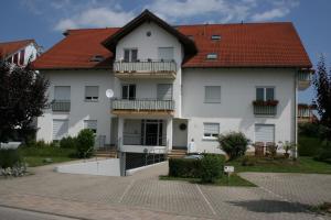 a large white house with a red roof at Ferienwohnung BELVEDERE in Rust
