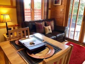 A seating area at Rashfield Sheilings - Riverside Lodges, by Pucks Glen, Dunoon