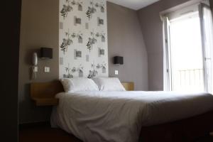Postel nebo postele na pokoji v ubytování Hotel du Touring