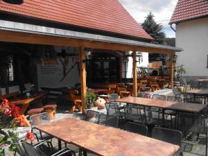 リンバッハ・オーバーフローナにあるRestaurant & Pension "Bauernhof zum Silberbergwerk"の屋外パティオ(テーブル、椅子付)、レストランを提供しています。 +6枚の写真