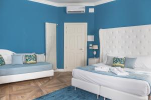 a bedroom with two beds and a blue wall at B&B La Residenza di Michelangelo in Florence