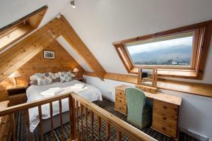 a bedroom with a bed and a large window at Berkeley House in Keswick