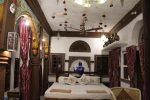 a bedroom with a bed in a room with a ceiling at Castle View Heritage Haveli in Jodhpur