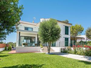 a white house with a tree in the yard at Holiday Home Marianne by Interhome in Can Picafort