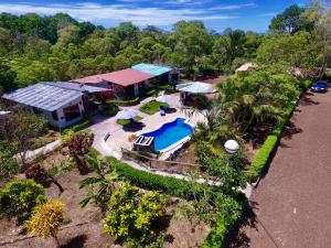 an aerial view of a house with a swimming pool at Piedras Blancas Lodge in Puerto Ayora