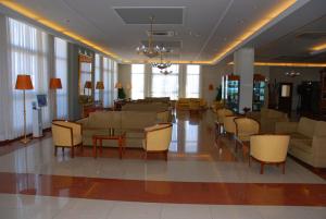 a lobby with couches and chairs in a building at Aktea Beach Village in Ayia Napa