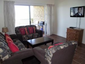 a living room with a couch and a coffee table at Ramsgate Palms J in Ramsgate